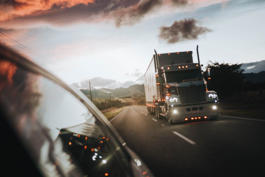 truck in the mirror of car